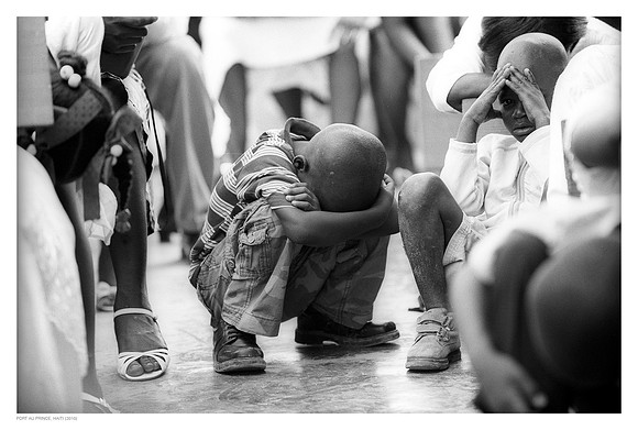 Child praying at Pastor Moise' destroyed church, Port au Prince, Haiti (2010)